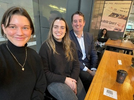 Heath with two students at a cafe