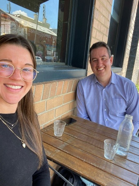 Heath mentoring a student over coffee in a Melbourne cafe